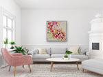 Load image into Gallery viewer, Fresh and joyful, this original painting with its red, coral and bright white abstract flowers against a warm white background displayed in a living room setting.
