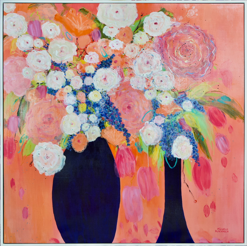 Vibrant and bold predominantly coral, orange, and pink background. Two navy based with coral, pink, and white flowers