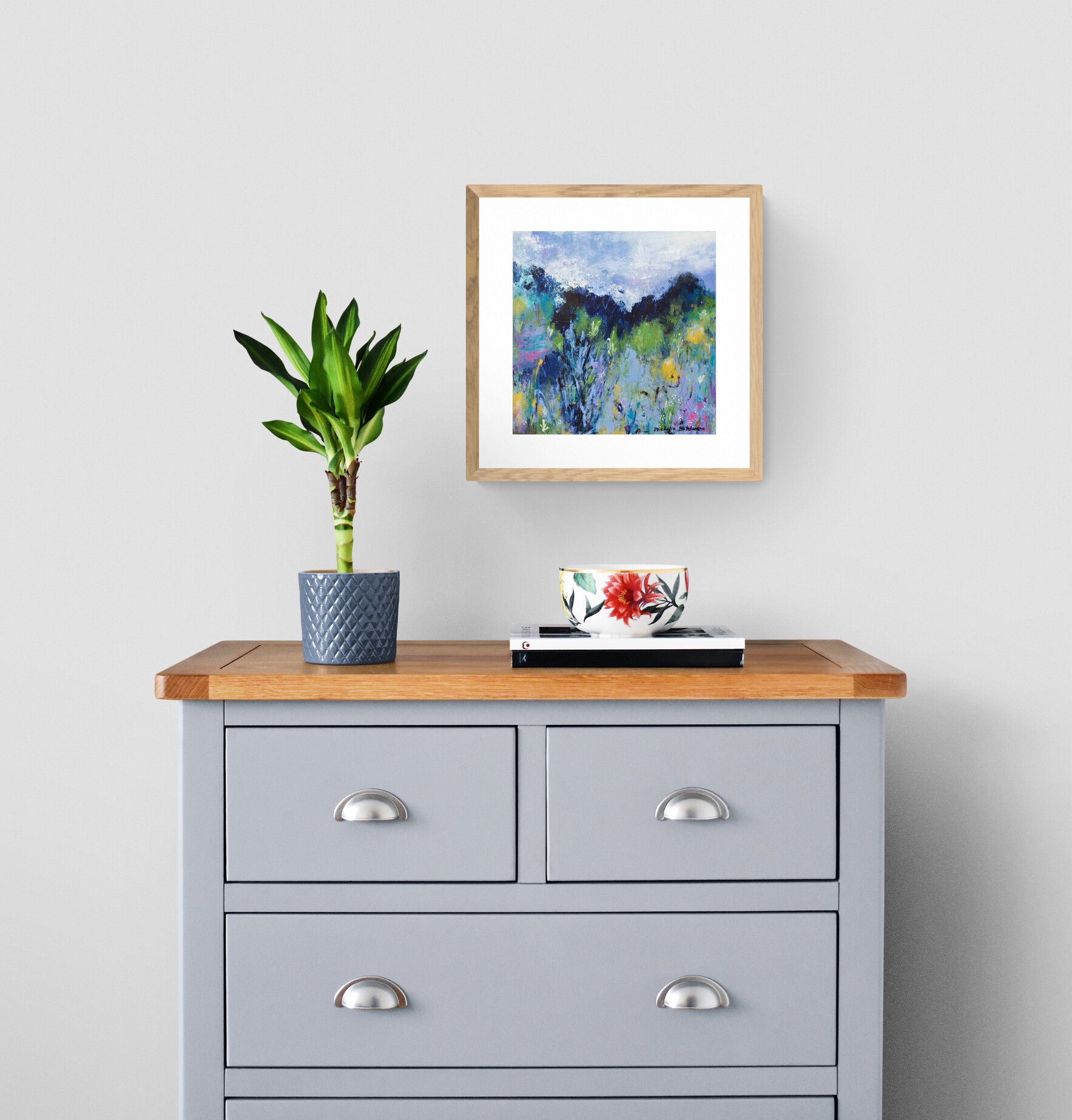 Inspired by a summer trip to the Canadian Rocky Mountains! Abstractly rendered meadow flowers of yellows and pinks and trees in greens draw the viewer's eye to the sky. New Vistas Await beckons us to absorb all the natural beauty around us and be inspired to try something new.