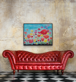 Load image into Gallery viewer, Vibrant art shown above a red leather sofa against a natural brick wall
