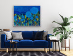 Load image into Gallery viewer, Predominantly blue floral painting shown above a blue velvet sofa.
