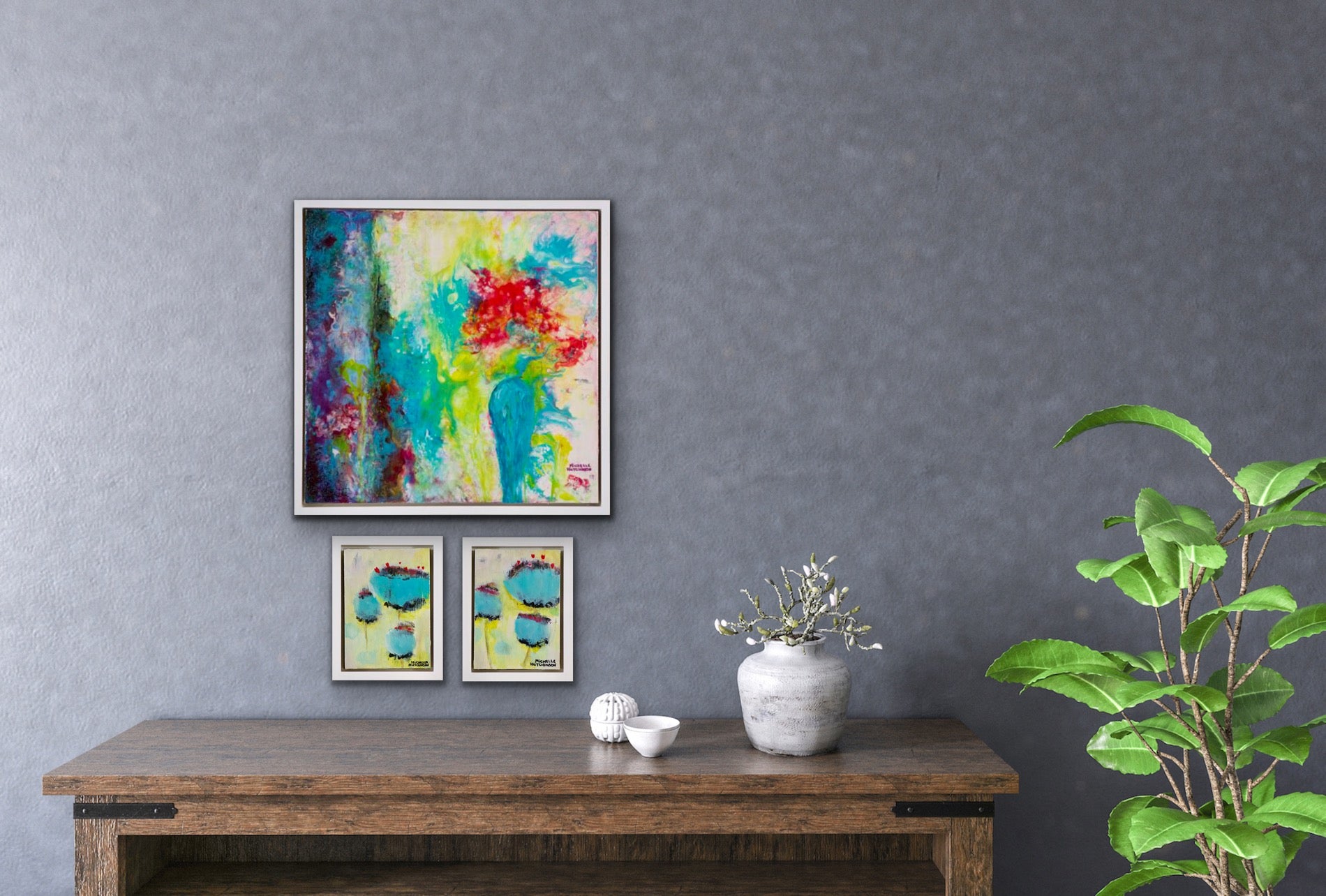 Offbeat and playful, this joyful original painting uses a technique called acrylic pouring. The red flowers sit within a teal vase beside blue drapes, inviting the viewer to gaze into the heart of love. It has a glossy finish. Displayed on a grey wall with two mini paintings above a console table.