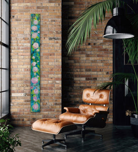 Gather painting displayed on a narrow brick wall beside a leather chair. Relaxing vibe!