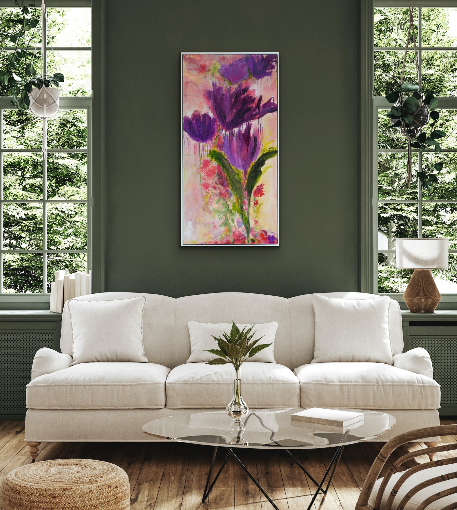 Large vertical painting displayed again a dark sage green wall above a cream sofa.