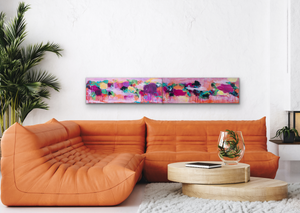 Two paintings (shown as a Diptych) above an orange sofa.