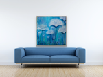 Load image into Gallery viewer, Peacefully captivating, white flowers with its background in blues and greens  displayed above a blue sofa.
